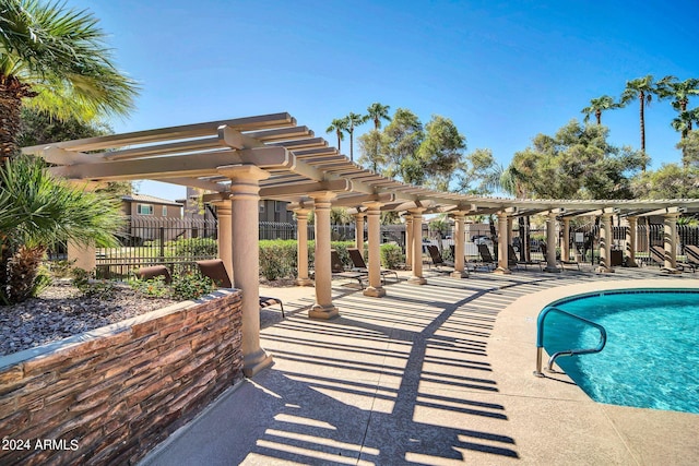 view of swimming pool with a pergola