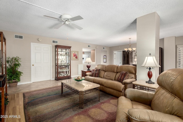 10330 W Thunderbird Blvd Unit C207, Sun City, AZ 85351 - tiled living room with ceiling fan, a textured ceiling, and a chandelier