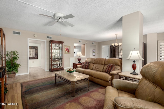 10330 W Thunderbird Blvd Unit C207, Sun City, AZ 85351 - living area featuring a ceiling fan, a chandelier, a textured ceiling, and light tile patterned floors