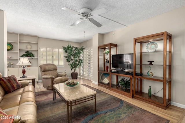 10330 W Thunderbird Blvd Unit C207, Sun City, AZ 85351 - living area with wood finished floors, a textured ceiling, and a ceiling fan