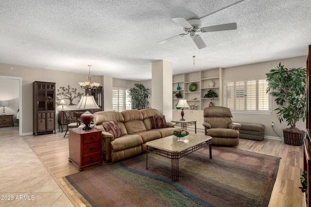 10330 W Thunderbird Blvd Unit C207, Sun City, AZ 85351 - living room featuring ceiling fan, a textured ceiling, a chandelier, and light wood-style flooring