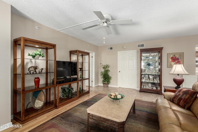 10330 W Thunderbird Blvd Unit C207, Sun City, AZ 85351 - living room with a ceiling fan, a textured ceiling, and tile patterned floors