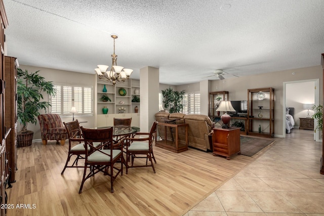 10330 W Thunderbird Blvd Unit C207, Sun City, AZ 85351 - dining room with a textured ceiling, a ceiling fan, a chandelier, and light wood-style floors