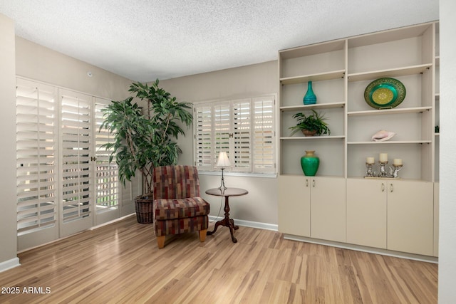 10330 W Thunderbird Blvd Unit C207, Sun City, AZ 85351 - living area with light wood-style floors and a textured ceiling