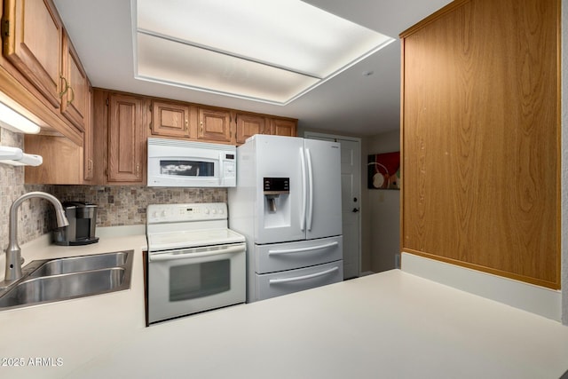 10330 W Thunderbird Blvd Unit C207, Sun City, AZ 85351 - kitchen featuring white appliances, light countertops, decorative backsplash, and brown cabinetry