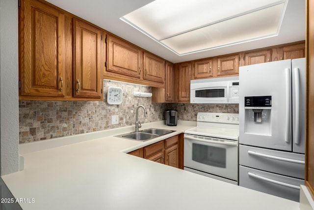 10330 W Thunderbird Blvd Unit C207, Sun City, AZ 85351 - kitchen with white appliances, light countertops, brown cabinets, and backsplash
