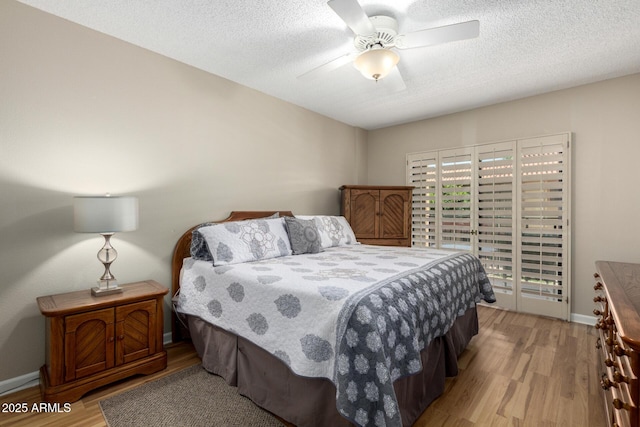 10330 W Thunderbird Blvd Unit C207, Sun City, AZ 85351 - bedroom with light wood-style flooring, a textured ceiling, and ceiling fan