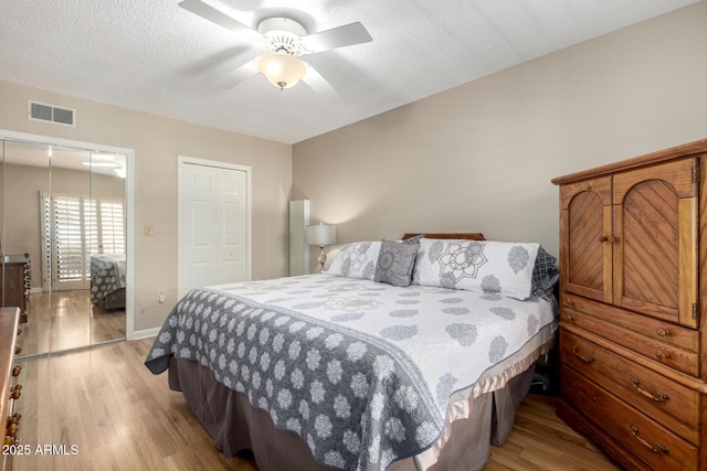 10330 W Thunderbird Blvd Unit C207, Sun City, AZ 85351 - bedroom with light wood-type flooring, ceiling fan, and a textured ceiling