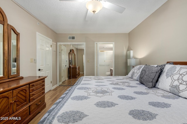 10330 W Thunderbird Blvd Unit C207, Sun City, AZ 85351 - bedroom featuring light wood-type flooring, a textured ceiling, ensuite bathroom, and a ceiling fan