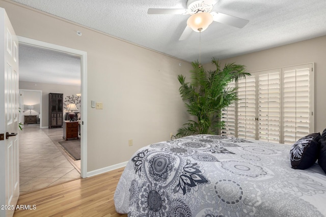 10330 W Thunderbird Blvd Unit C207, Sun City, AZ 85351 - bedroom with light wood-style floors, a textured ceiling, and a ceiling fan