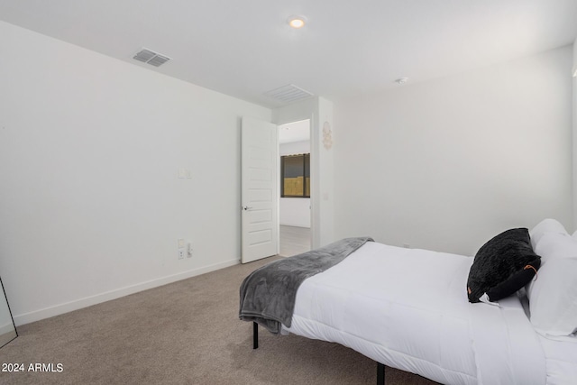 carpeted bedroom with visible vents and baseboards