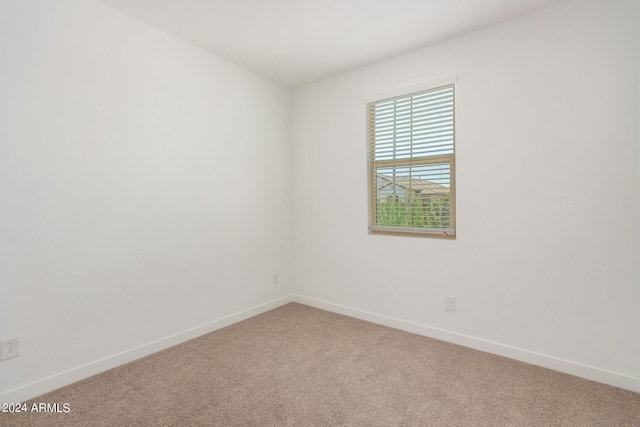 carpeted spare room with baseboards