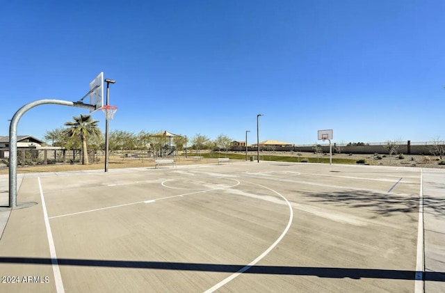 view of basketball court with community basketball court and fence