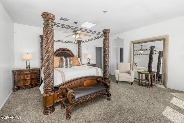 carpeted bedroom with ceiling fan and a skylight