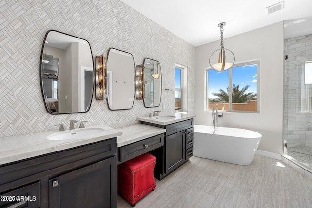 bathroom featuring tile walls, vanity, and separate shower and tub