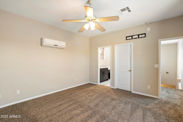 unfurnished bedroom with carpet floors, ensuite bath, ceiling fan, and a wall unit AC