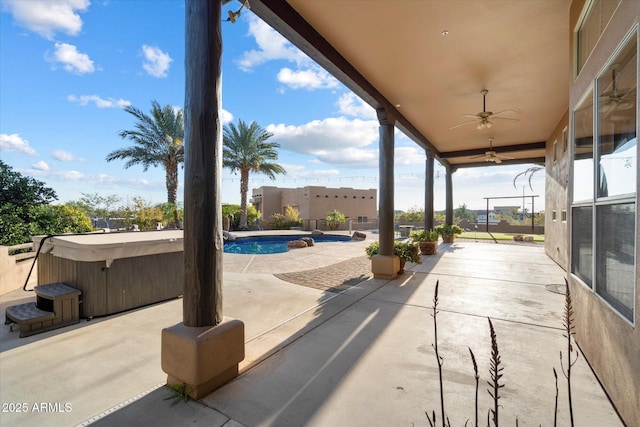 view of patio / terrace featuring a pool with hot tub and ceiling fan