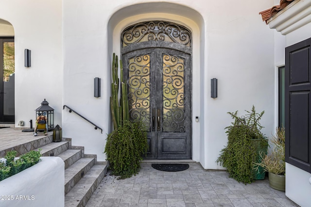 view of exterior entry featuring stucco siding