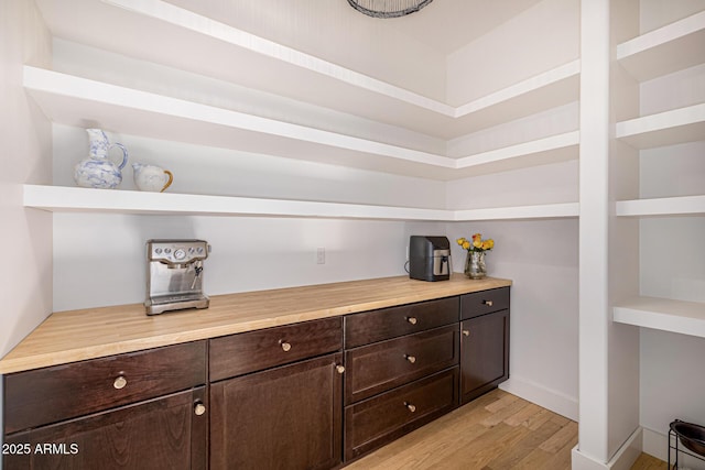 bar featuring light wood finished floors and baseboards