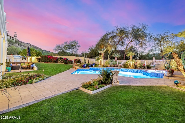 view of pool with a patio, a mountain view, and a pool with connected hot tub