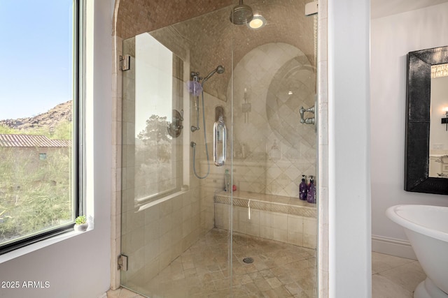 bathroom featuring a stall shower, tile patterned flooring, and baseboards