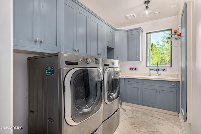 laundry area with cabinet space, separate washer and dryer, and light marble finish flooring