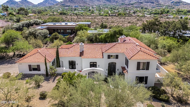 aerial view of property and surrounding area with a mountain backdrop