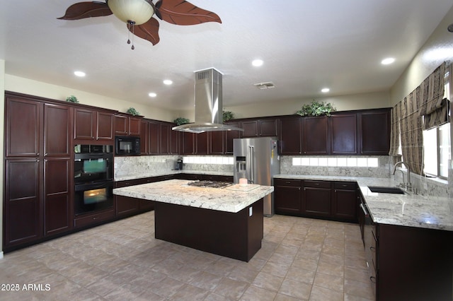 kitchen featuring visible vents, a sink, ceiling fan, black appliances, and island exhaust hood