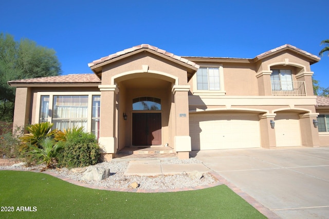 view of front facade featuring driveway, stucco siding, and a garage