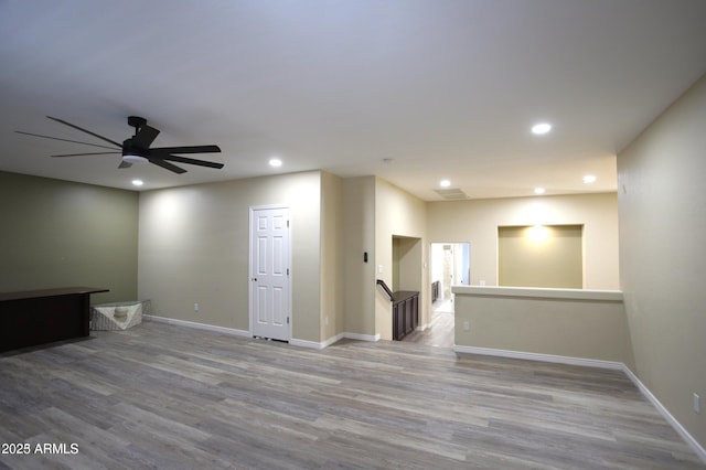 unfurnished living room featuring recessed lighting, baseboards, a ceiling fan, and wood finished floors