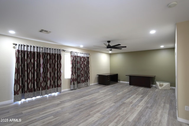 unfurnished living room featuring visible vents, baseboards, a ceiling fan, recessed lighting, and wood finished floors