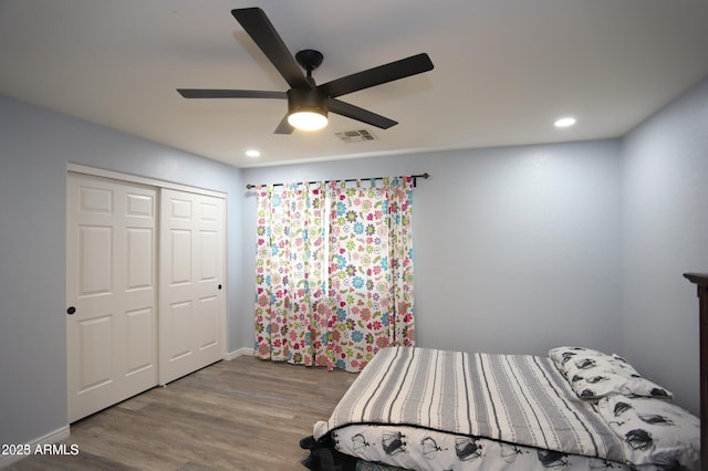 bedroom with a closet, recessed lighting, a ceiling fan, visible vents, and wood finished floors