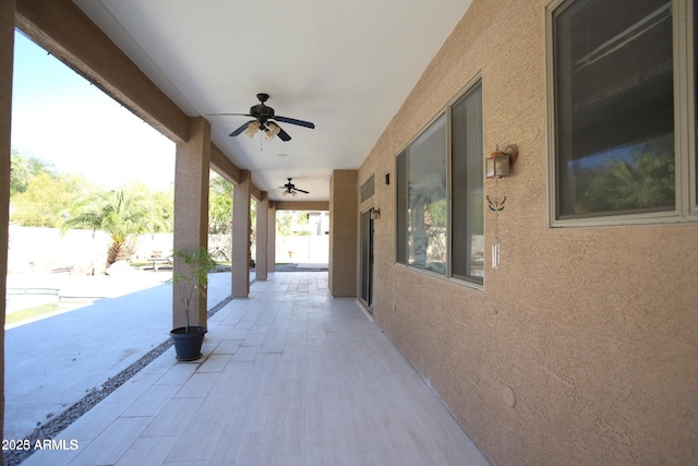 view of patio featuring ceiling fan and fence