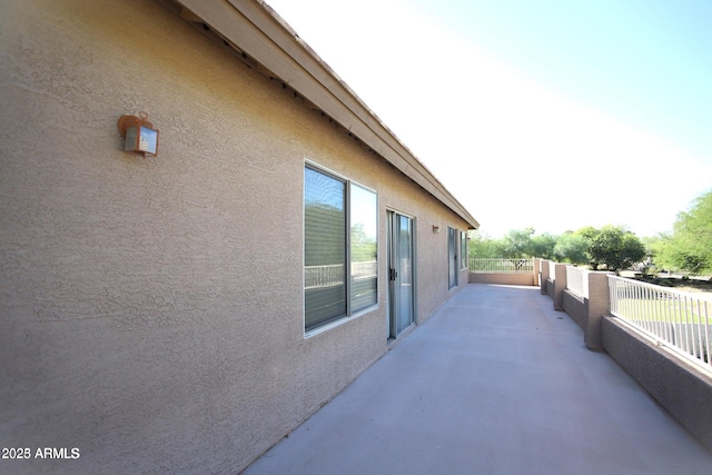 view of side of property featuring stucco siding