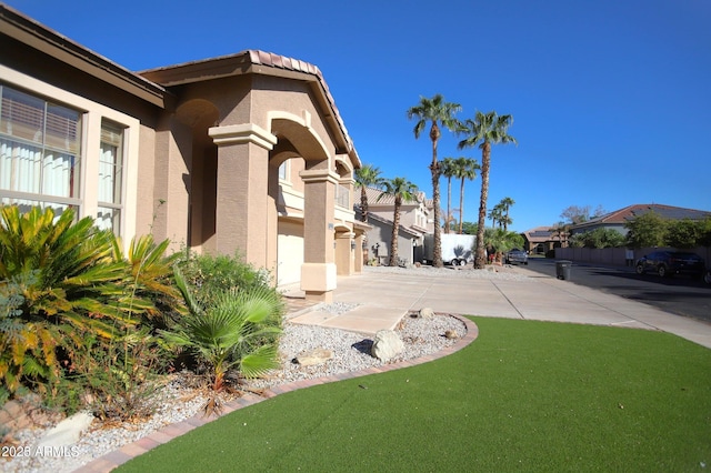 exterior space with a yard and stucco siding