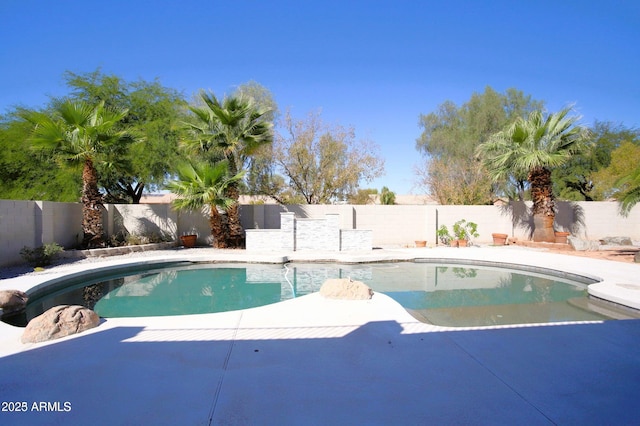 view of swimming pool featuring a fenced backyard, a fenced in pool, and a patio area
