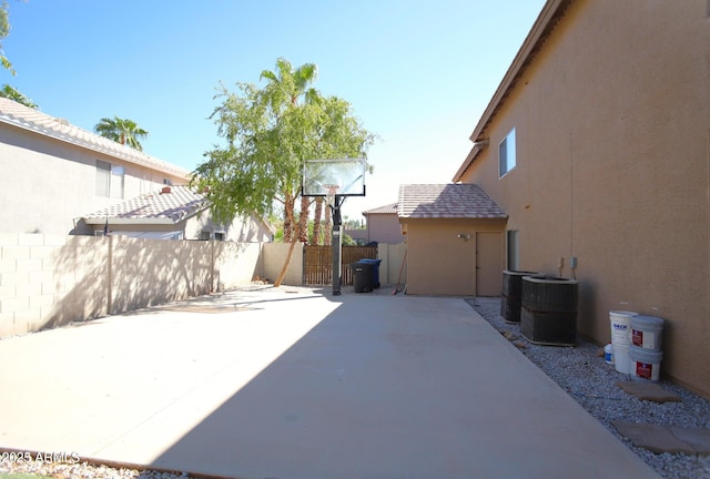 view of patio / terrace with central AC unit and fence