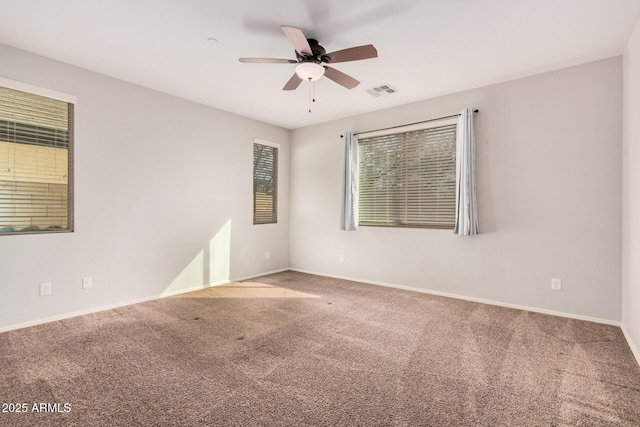 empty room featuring carpet flooring, ceiling fan, and baseboards