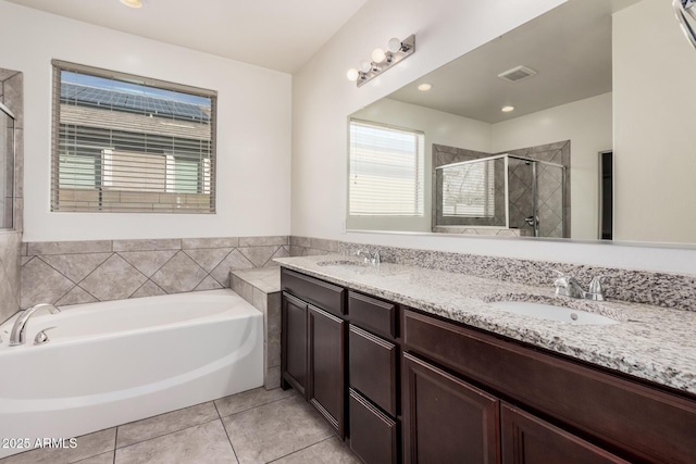 full bathroom featuring a shower stall, a bath, tile patterned floors, and double vanity
