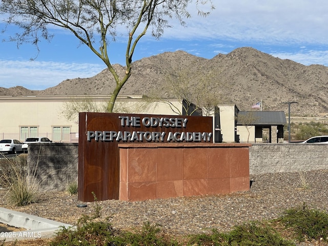 community / neighborhood sign with a mountain view