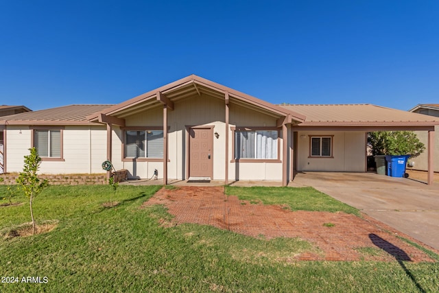 ranch-style house featuring a front yard and a carport