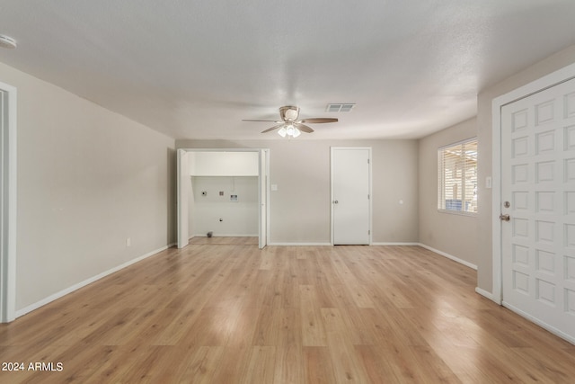 interior space featuring light hardwood / wood-style flooring, ceiling fan, and a textured ceiling