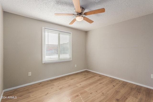 spare room with a textured ceiling, light hardwood / wood-style floors, and ceiling fan