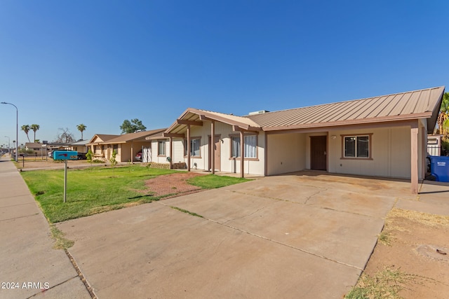 single story home featuring a carport and a front lawn