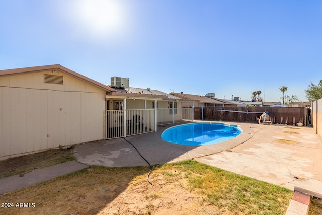 view of pool with a patio and central AC unit