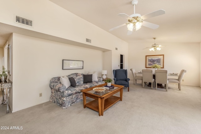 living room featuring vaulted ceiling, light carpet, and ceiling fan