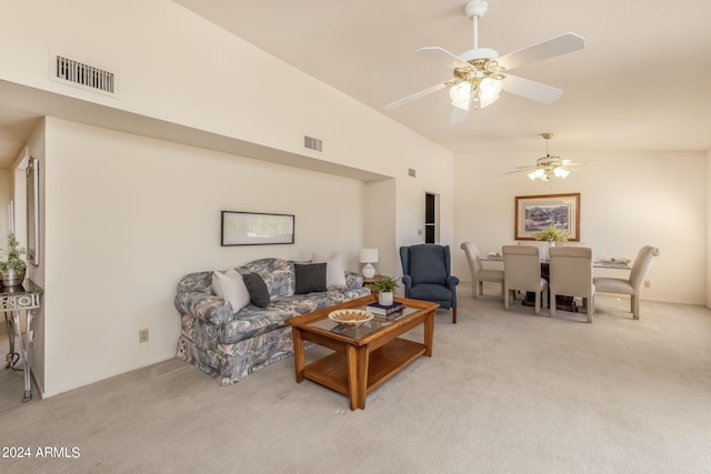 living room featuring high vaulted ceiling, ceiling fan, visible vents, and light carpet