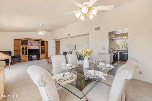 carpeted dining area featuring vaulted ceiling and ceiling fan