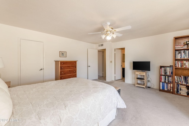 bedroom featuring light carpet, visible vents, and ceiling fan