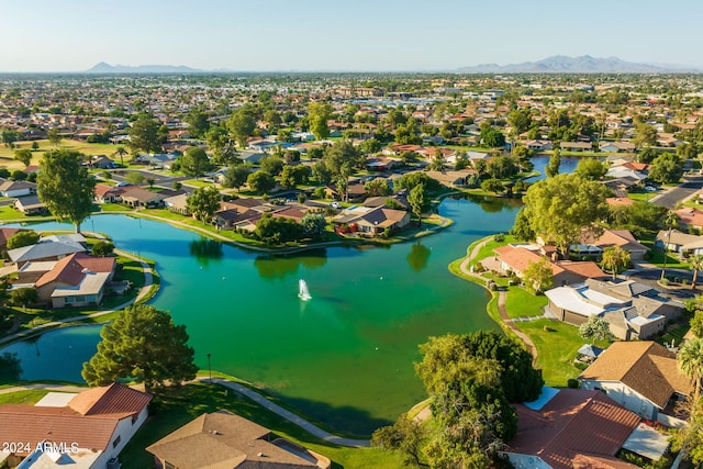 drone / aerial view with a water and mountain view and a residential view